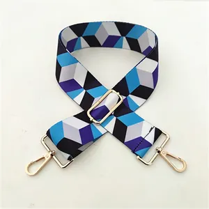 Adjustable wide replacement bag strap with blue and grey geometric pattern and gold hardware