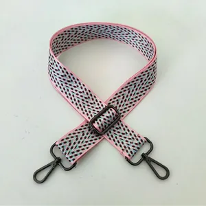 Detail view of ethnic pink woven replacement bag strap with black No. 101 lobster clasp