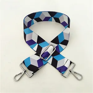 Detail of adjustable geometric strap with blue and purple patterns and silver buckle
