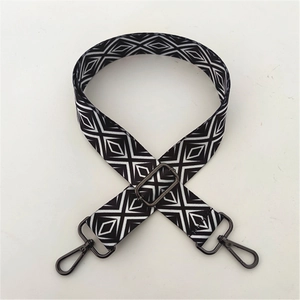 Close-up of adjustable woven shoulder strap with black and white diamond pattern