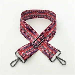 Detail view of woven geometric guitar strap for handbags with gunmetal clasp