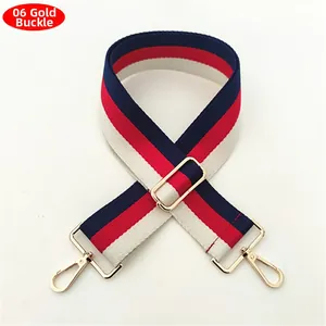 Detail of red white and blue striped wide woven guitar strap with gold metal buckles