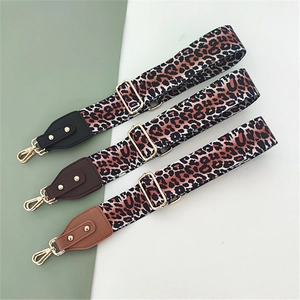 Adjustable leopard print bag straps with leather ends and gold metal buckles for handbags
