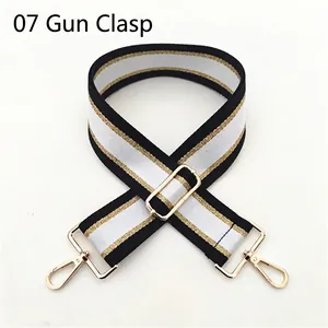 Detail of Style 07 woven shoulder strap with black, white, gold stripes and metal clasps