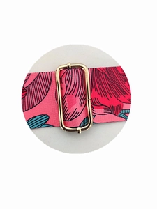 Detail of pink floral handbag strap featuring a premium gold metal adjustment buckle