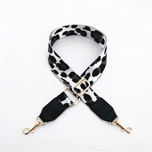 Close-up of leopard print strap with adjustable gold metal buckle and leather ends