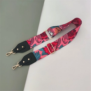 Macro detail of adjustable pink floral strap with premium gold swivel metal buckles