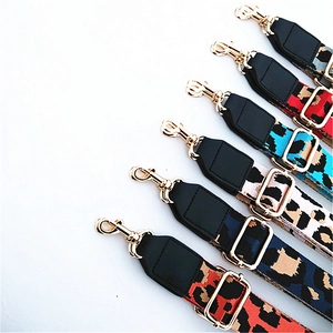 Detail of adjustable leopard print bag straps with golden metal hooks in multiple colors