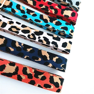 Detailed view of colorful leopard print woven bag straps with durable metal buckles