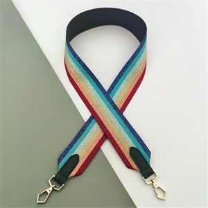 Macro detail of rainbow woven bag strap with golden metal hooks and black leather