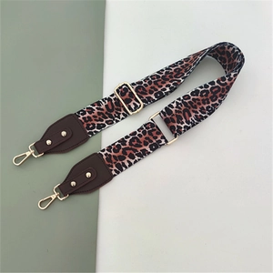 Close-up of adjustable leopard print bag strap with high-quality metal lobster clasps