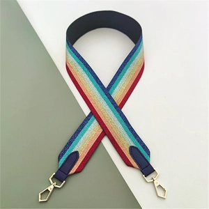 Close-up of rainbow striped shoulder strap with golden metal hooks and blue leather details