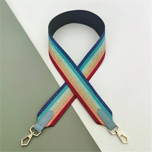 Close-up of colorful striped bag strap with glitter texture and gold metal hooks