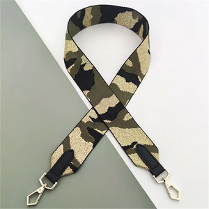 Macro view of wide camo strap with gold snap hooks and black leather reinforced ends