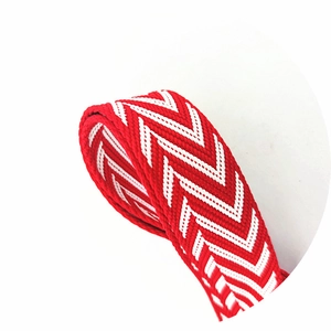 Detailed macro view of the red and white herringbone pattern adjustable shoulder strap