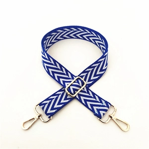 Adjustable patterned shoulder strap with blue wave weave and gold metal hardware for bags