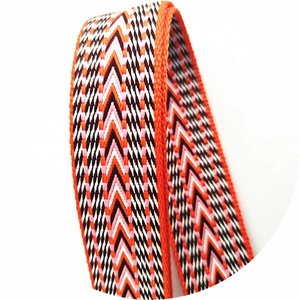 Close-up of thick ethnic style woven bag strap with orange and pink herringbone patterns