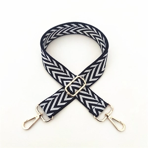 Detail of navy and white chevron woven strap with adjustable gold-tone metal hardware