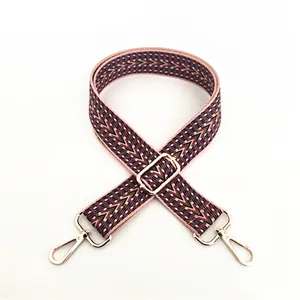 Detailed close-up of No.10 ethnic pink and green woven strap with gold metal hooks
