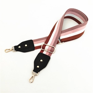 Adjustable wide striped purse strap with gold hardware and colorful woven patterns