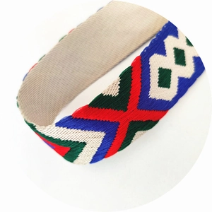 Close-up of ethnic geometric woven strap with colorful diamond and chevron embroidery