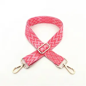 Ethnic style pink and white woven adjustable shoulder strap with gold metal hardware