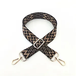 Detail of ethnic style woven bag strap with golden metal buckle and wave pattern