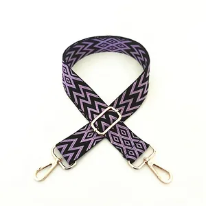 Detail view of ethnic purple geometric woven strap with light gold metal lobster clasps