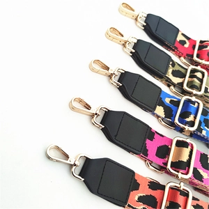 Detail of adjustable leopard print bag straps with gold metal lobster clasps and leather ends