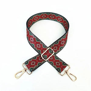 Adjustable folk-style woven shoulder strap with geometric patterns and gold metal buckles