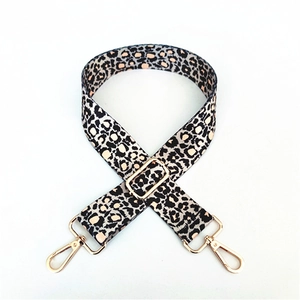 Adjustable leopard print replacement shoulder strap with gold metal hooks on white background