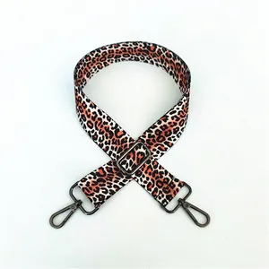 Close-up of leopard print adjustable bag strap with dark grey metallic swivel hooks
