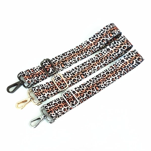 Detail showing leopard print bag straps with three metal hardware finishes in gold, silver, and black