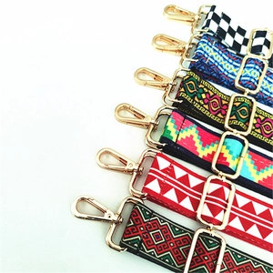 Detail view of adjustable ethnic style woven shoulder straps with golden metal swivel hooks