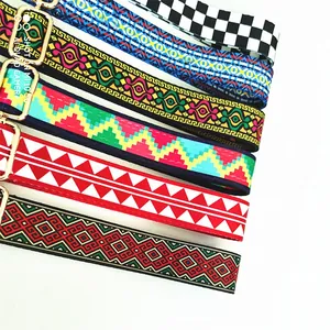 Close-up of adjustable ethnic style bag straps with jacquard patterns and gold metal clips