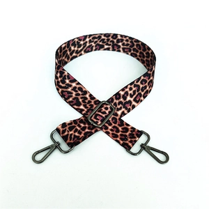 Detail of adjustable leopard print bag strap with gunmetal swivel hooks for crossbody bags