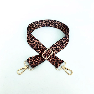 Detail of adjustable leopard print bag strap with polished gold-tone metal lobster clasps