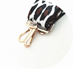 Detail of adjustable leopard print wide strap with high-gloss gold metal lobster clasps