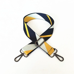 Detail of adjustable geometric striped cotton shoulder strap with black metal hooks