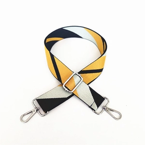 Adjustable geometric woven bag strap in yellow and black with silver metal hooks