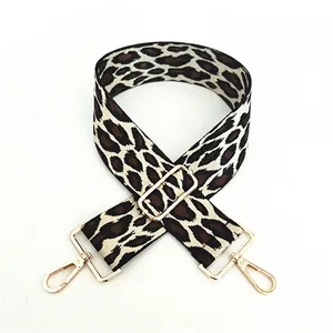 Close-up of leopard print wide replacement bag strap with gold-tone metal hooks