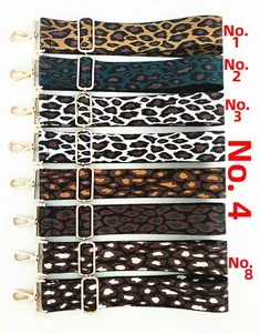 Macro shot showing eight leopard print wide bag straps with gold metal hardware