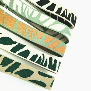 Close-up of adjustable jacquard woven bag straps featuring colorful abstract patterns