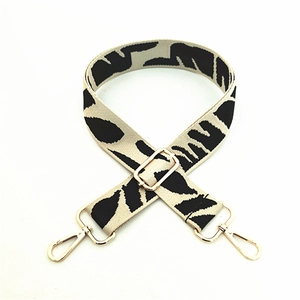 Adjustable black and white leaf pattern shoulder strap with gold metal lobster clasps