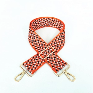 Adjustable wide woven shoulder strap with orange and black chevron pattern and gold clips