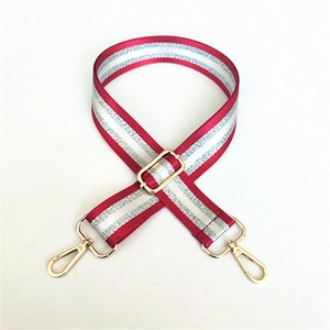 Adjustable red and silver striped bag strap with gold metal swivel snap hooks
