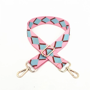 Pink bohemian woven bag strap with diamond pattern and light gold metal hardware