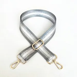 Adjustable gray bag strap with silver glitter stripes and shiny gold metal lobster clasps