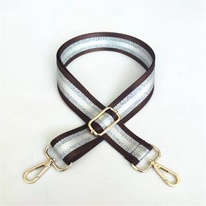 Macro shot of adjustable brown and silver woven strap with polished gold-tone metal buckles