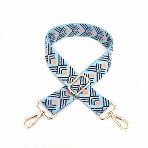 Adjustable ethnic style woven shoulder strap with blue geometric pattern and gold hardware